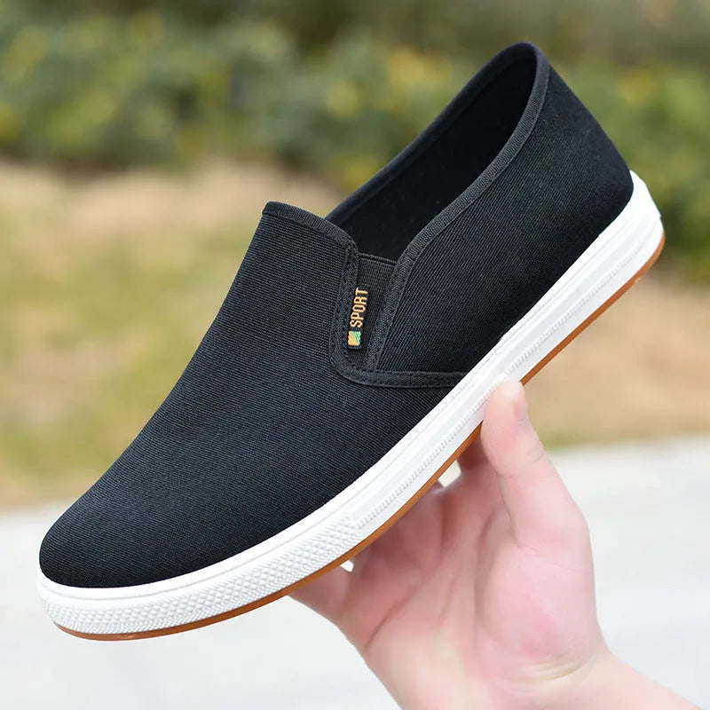 Men's low-top black and blue canvas slip-on shoes with round toe and shallow cut.