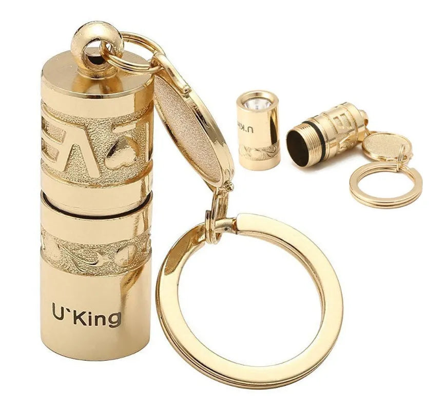Gold-coloured waterproof mini LED flashlight on a keychain ring.