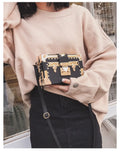 Hard-shell women's shoulder bag with single strap, flap closure, and decorative rivet details in black or green colour