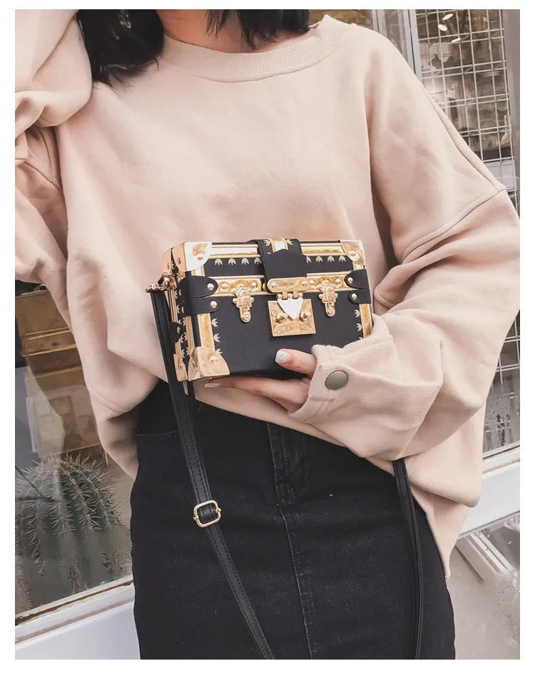 Hard-shell women's shoulder bag with single strap, flap closure, and decorative rivet details in black or green colour