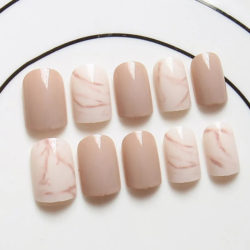 24 light khaki smudge false nails with glue in almond shape on white background