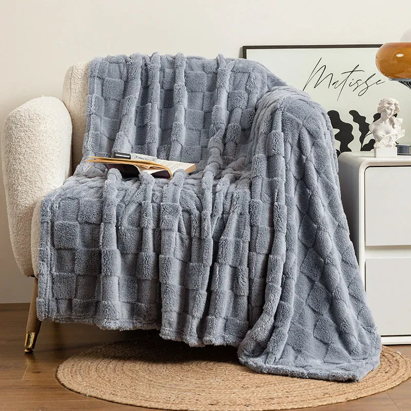 Thickened polyester blanket with geometric pattern in creamy white on a sofa