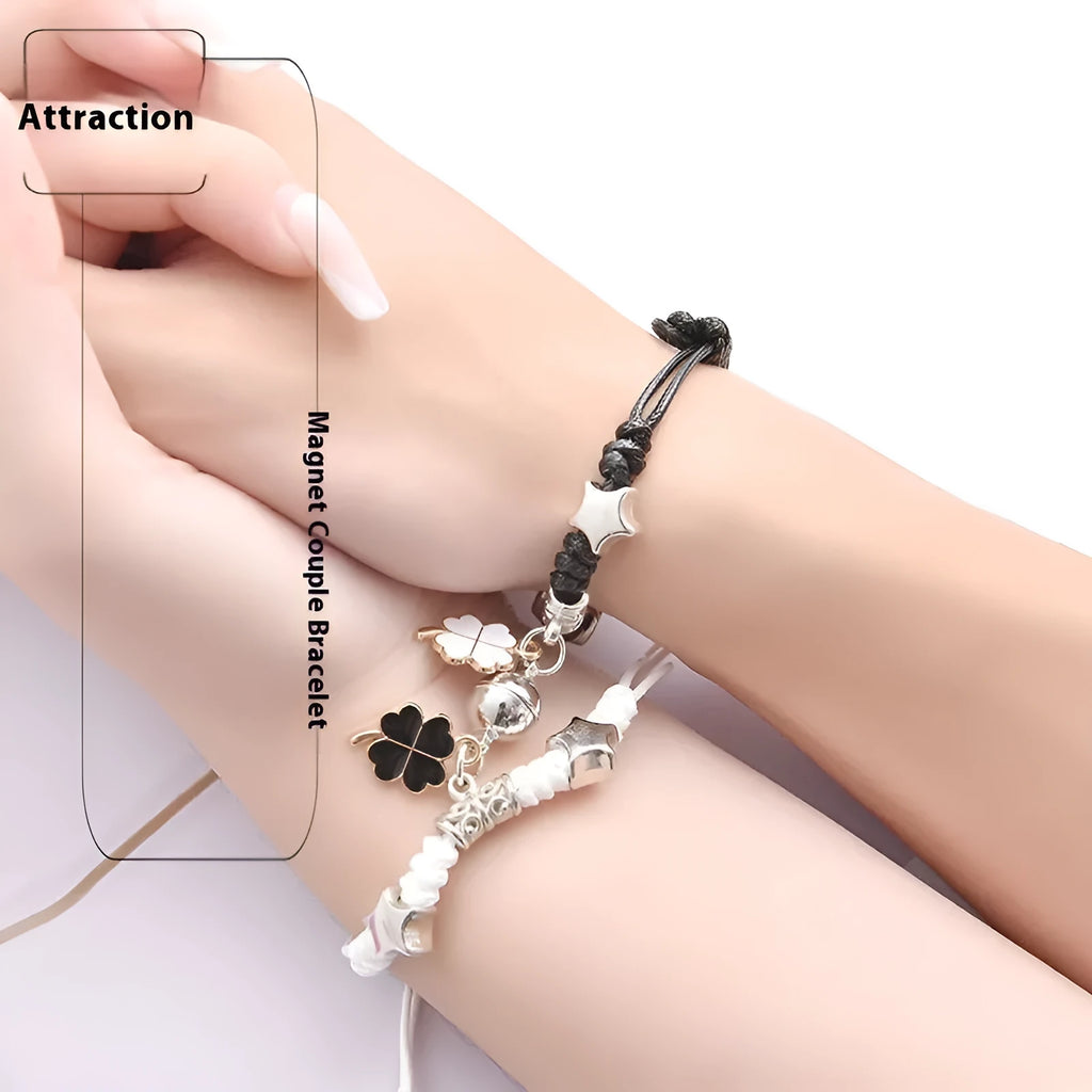 A pair of silver alloy bracelets with magnetic clasps and assorted charm designs including crowns, stars, and clovers.