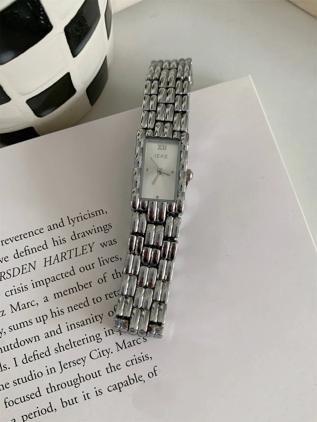 Slender 7mm thick women's mid-century bracelet watch with butterfly buckle on wrist.