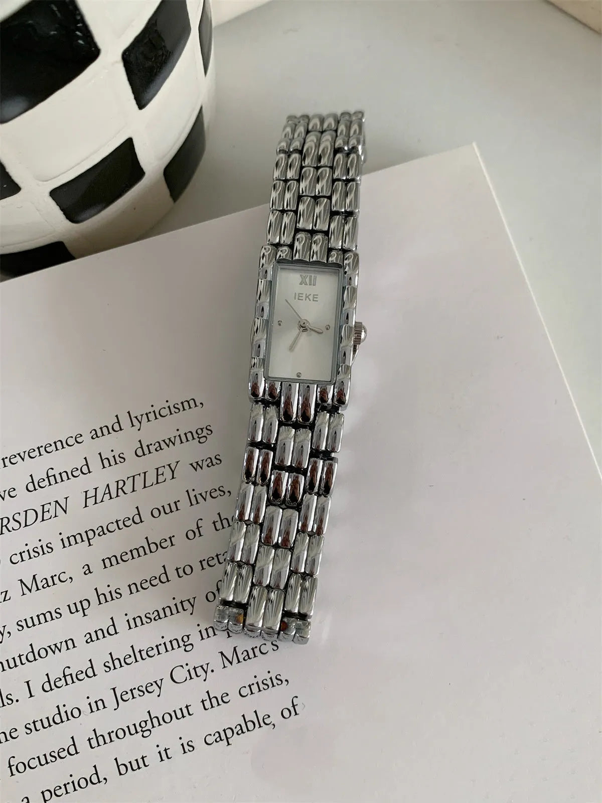 Slender 7mm thick women's mid-century bracelet watch with butterfly buckle on wrist.