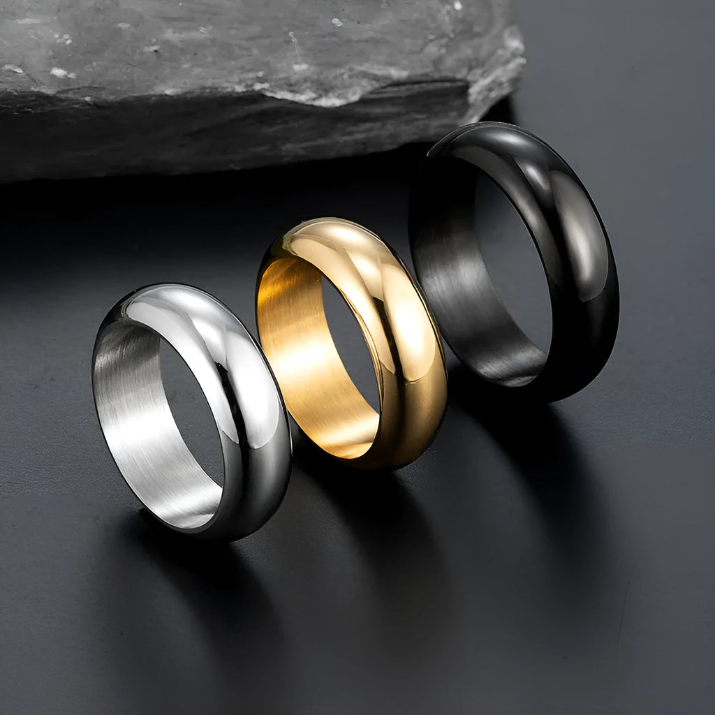 Glossy electroplated titanium steel ring shown in gold, black, and steel colour on a size chart