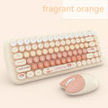 Candy pink wireless keyboard and mouse set with compact design on a desk.