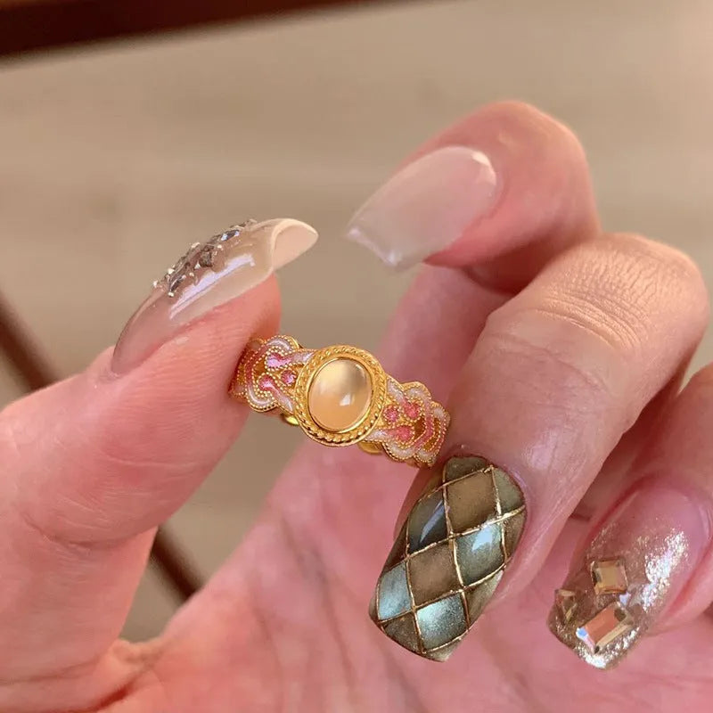 Women's open mouth ring with geometric shape, gold plating, and pink crystal enamel accents