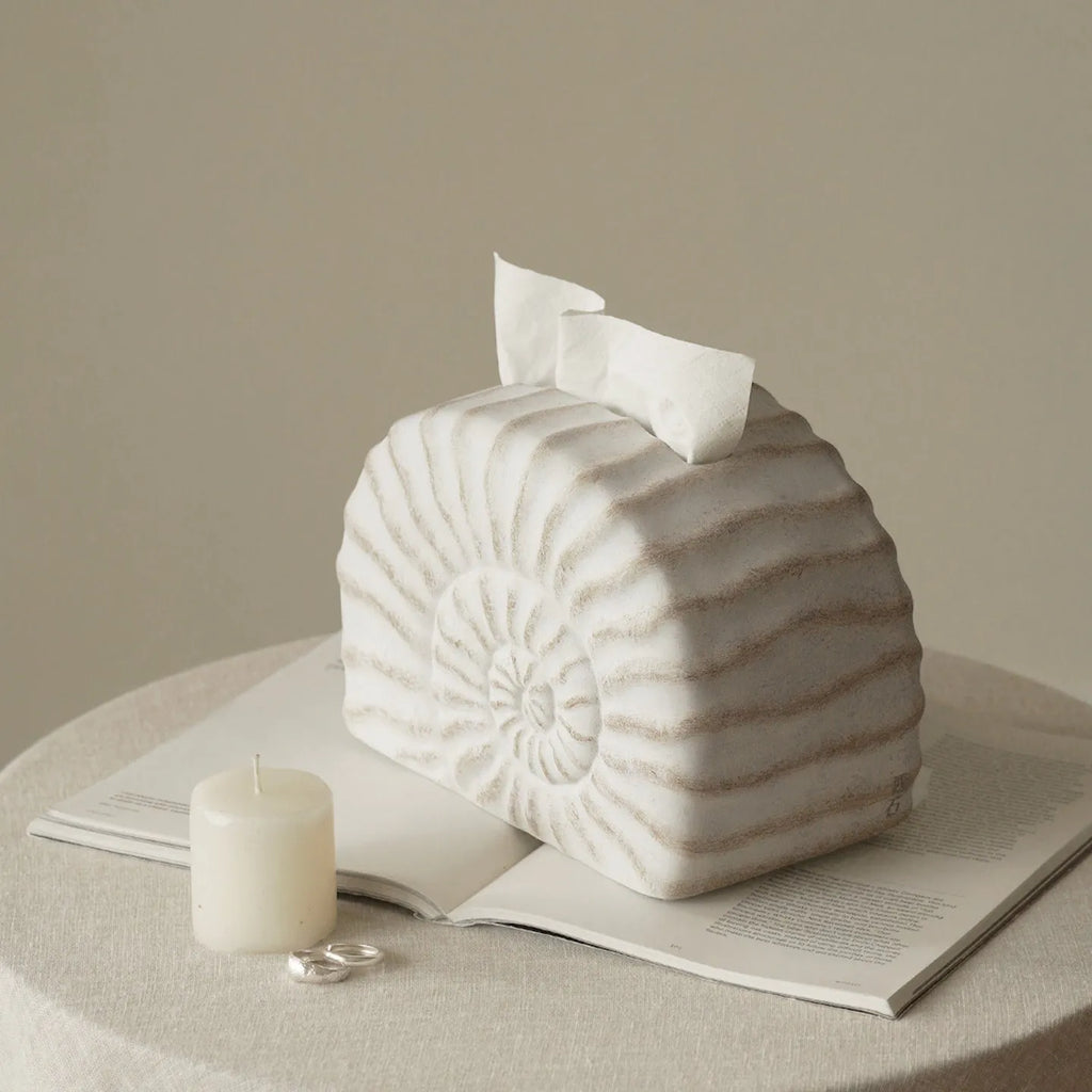 Modern conch ramble patterned resin decorative tissue box holder on a table.