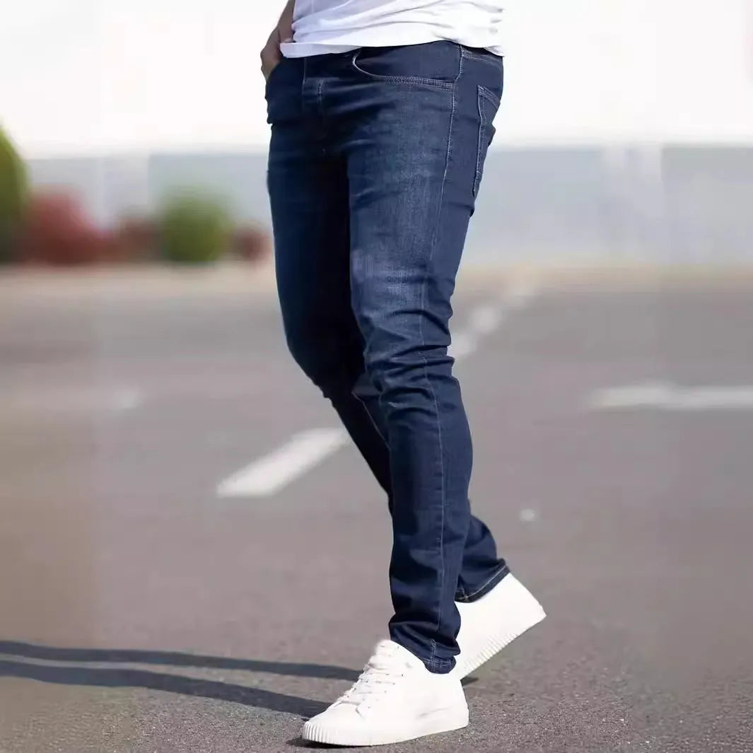 Dark blue men's slim fit cotton jeans with a skinny leg opening on a mannequin