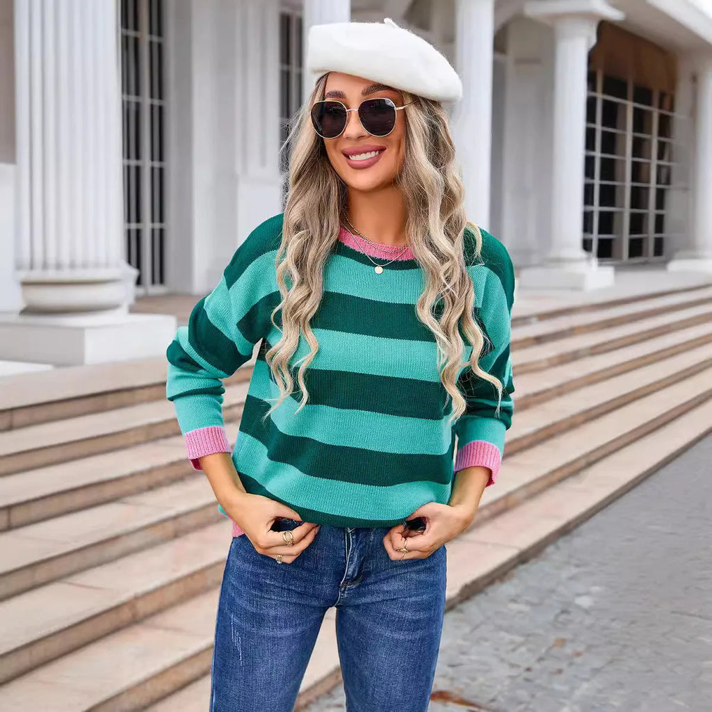 Women's loose fit long sleeve acrylic sweater in blue with a striped pattern, showing round neck.