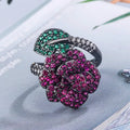 Women's black gold-plated geometric ring with red simulated corundum stones on a copper base.