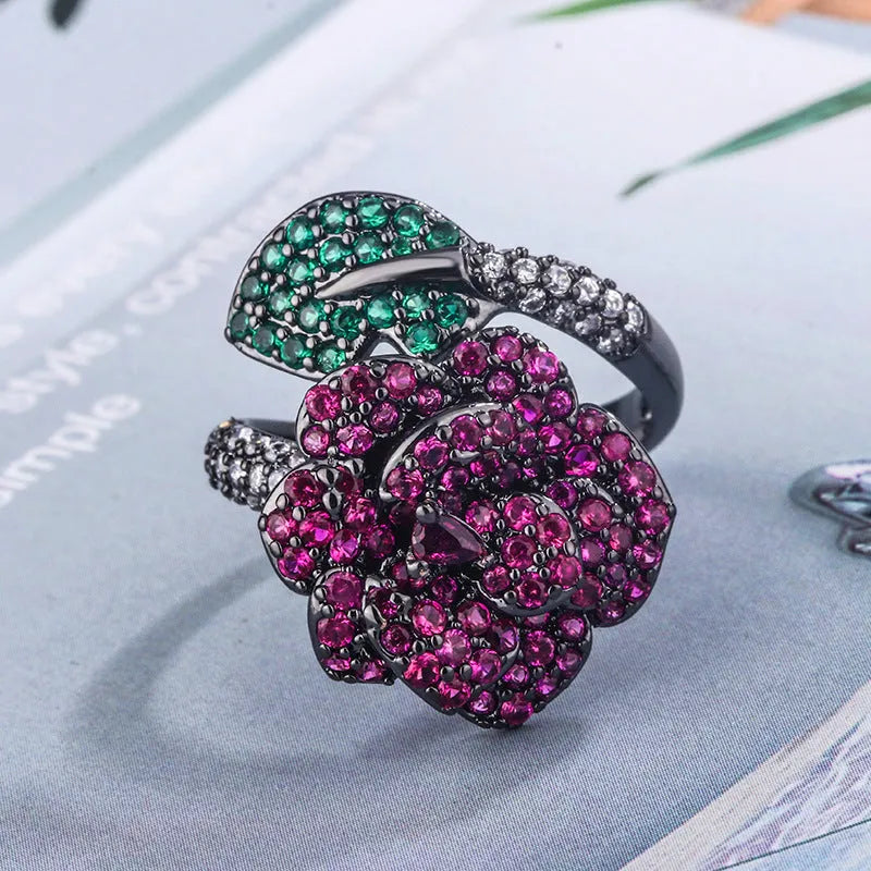Women's black gold-plated geometric ring with red simulated corundum stones on a copper base.