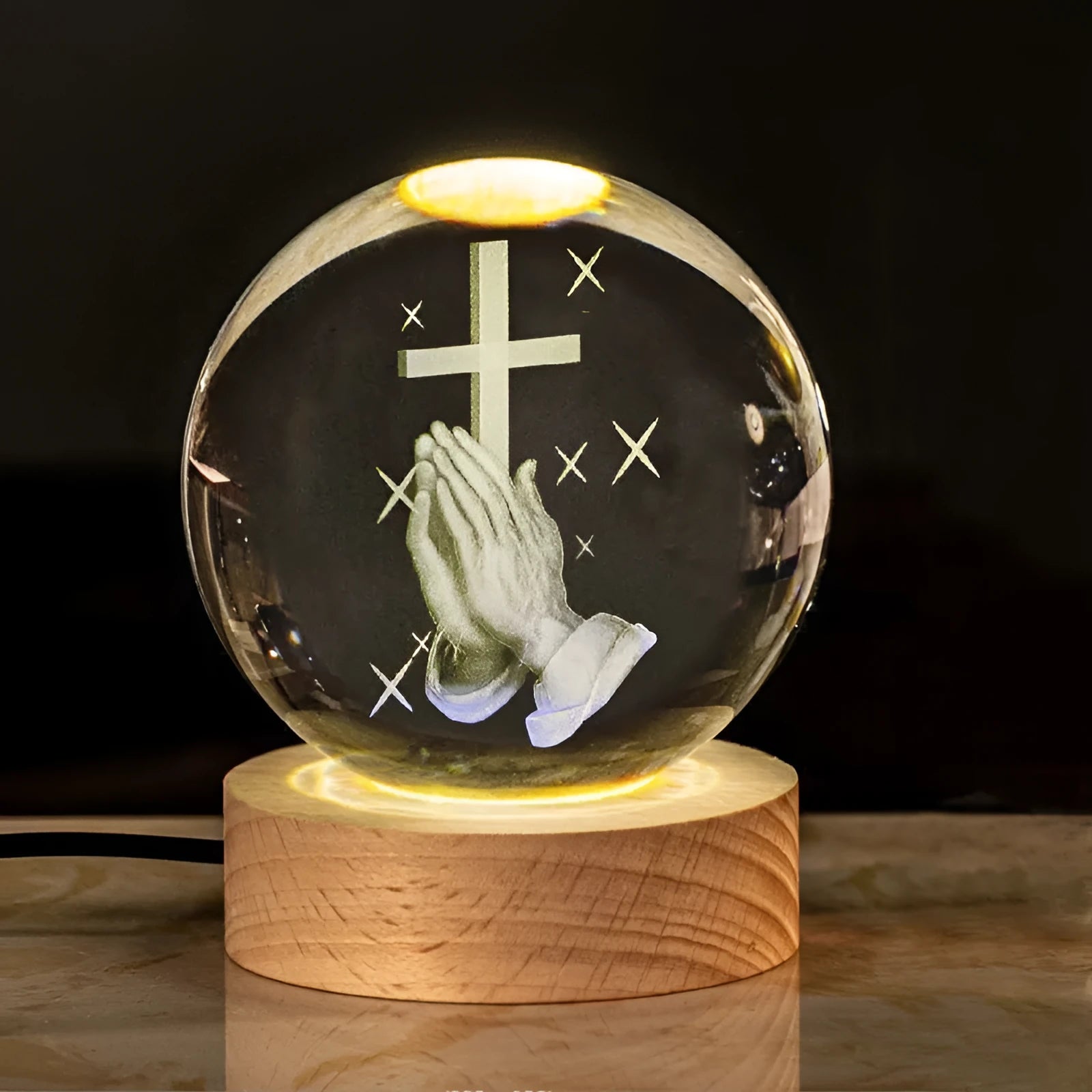 White crystal ball ornament with solid wood warm light base on desk surface