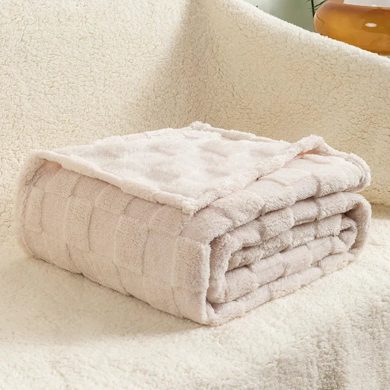 Thickened polyester blanket with geometric pattern in creamy white on a sofa
