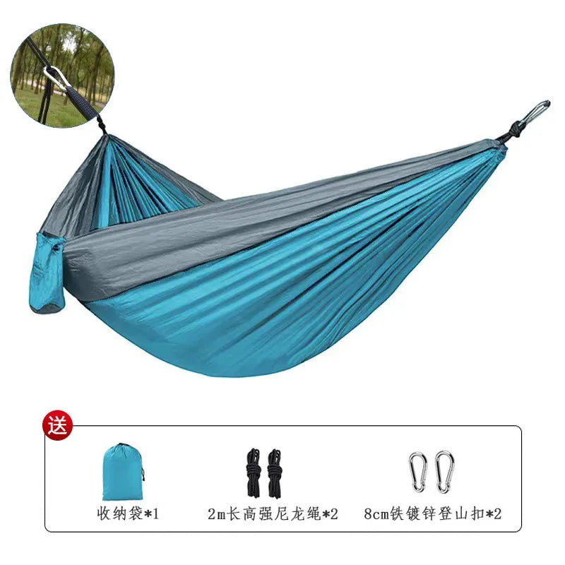 Blue nylon parachute cloth outdoor hammock with 300kg capacity hanging between trees