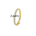 A stainless steel seamless nose ring with a small diamond stud, shown in gold, rose gold, steel, and black colour finishes.