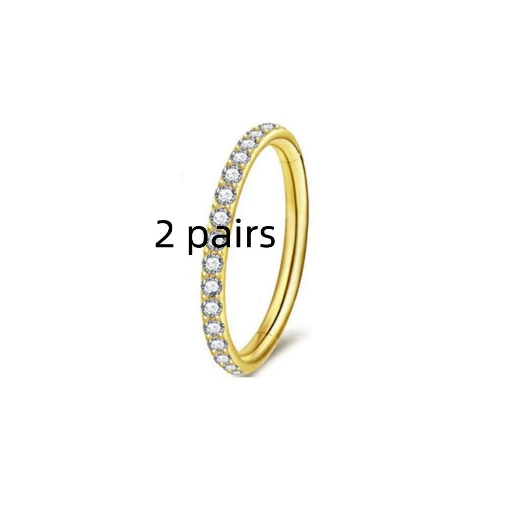 A stainless steel seamless nose ring with a small diamond stud, shown in gold, rose gold, steel, and black colour finishes.