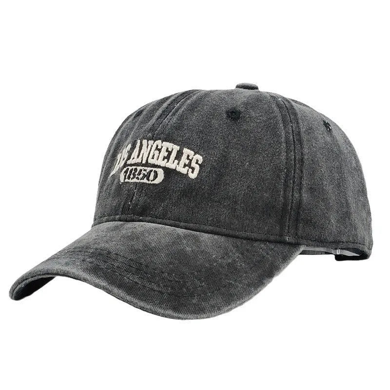 Adjustable peak cap with embroidered letters in distressed retro style, showing conical crown and 7cm brim
