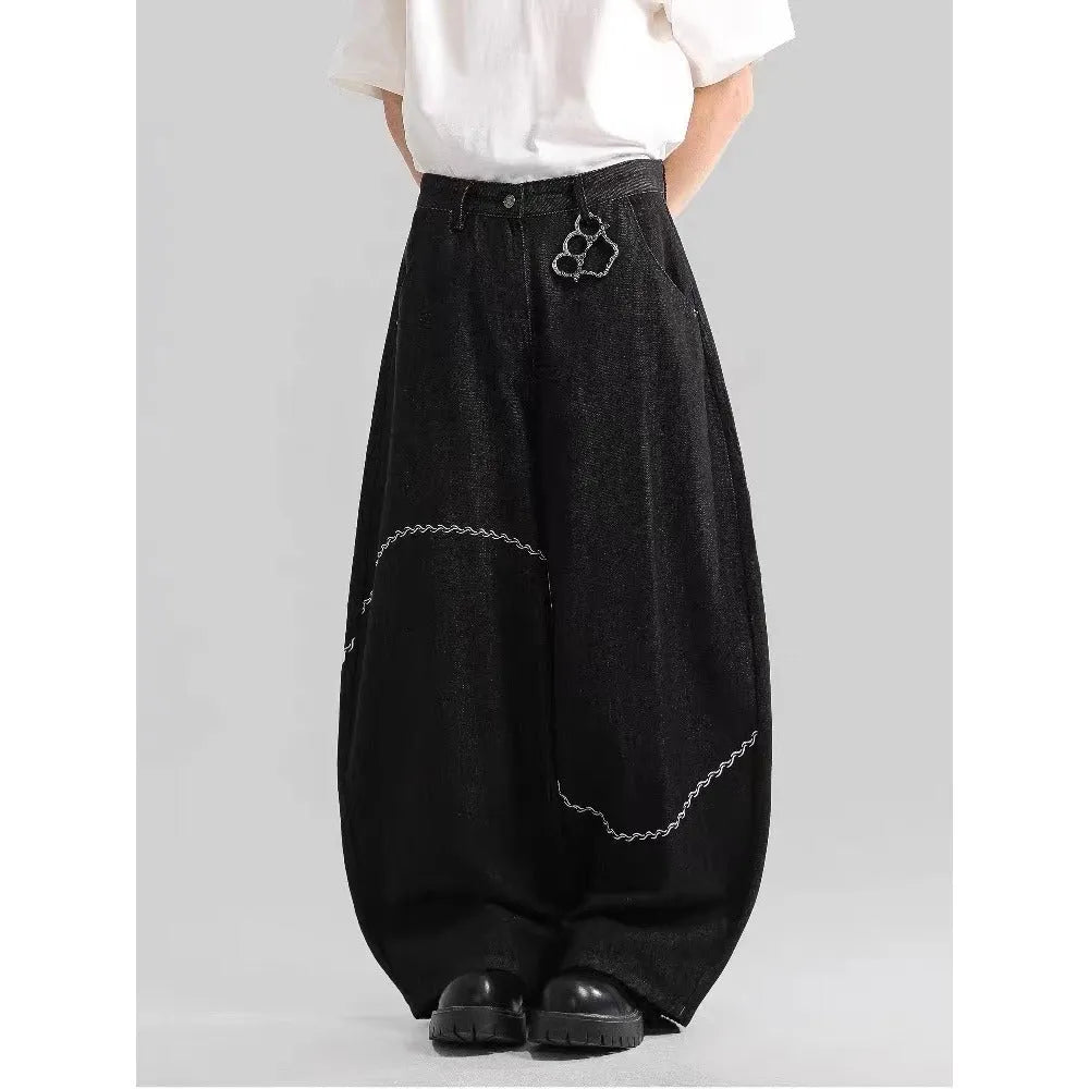 Black Pu Shuai straight-leg denim trousers with a mid waist and zip fly, laid flat.