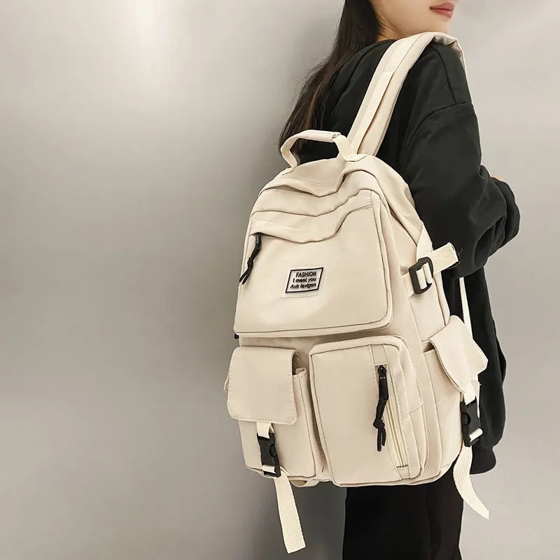 Black and white student nylon backpack with laptop compartment and outer pockets.