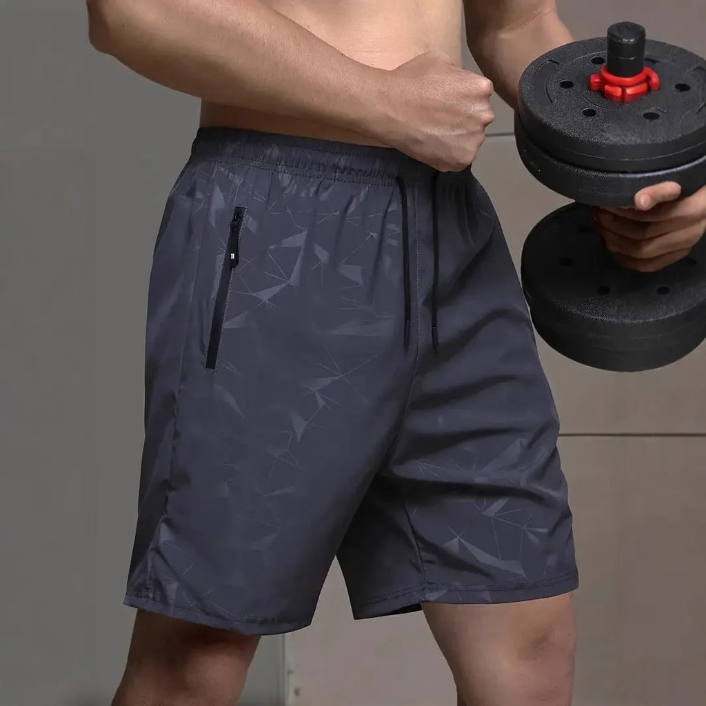 Man wearing loose grey polyester sports shorts, showing athletic loose fit and casual style.