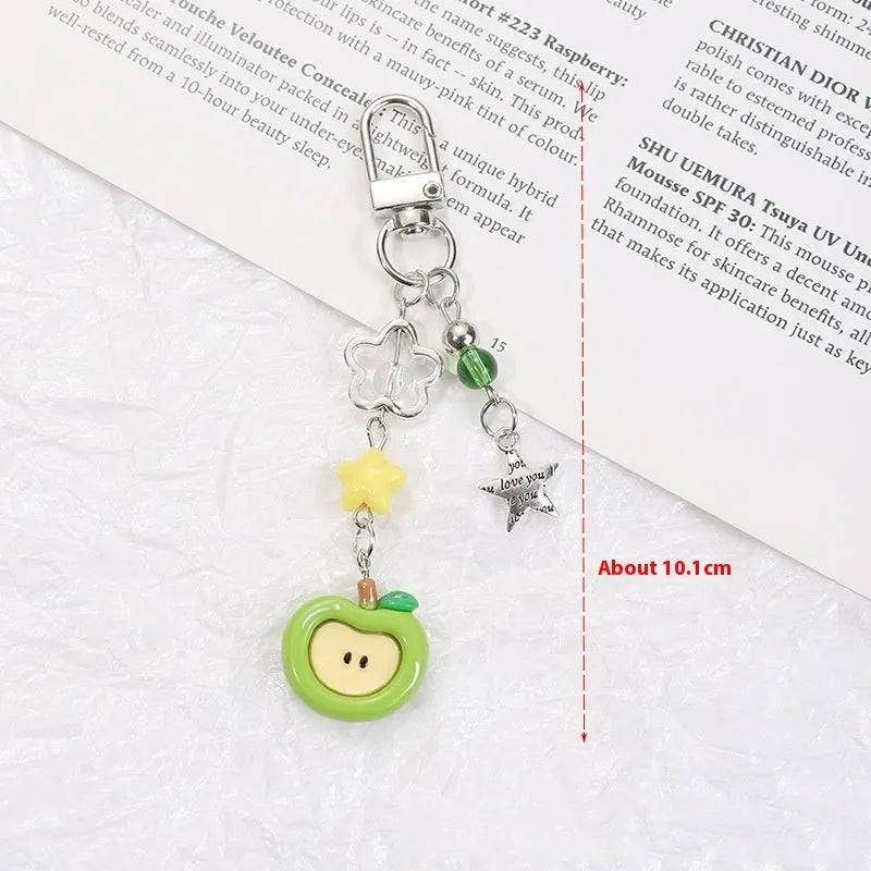 Fruit-shaped mobile phone bag pendant keychain in plastic resin with apple and strawberry design, half-handmade finish, multiple colour options