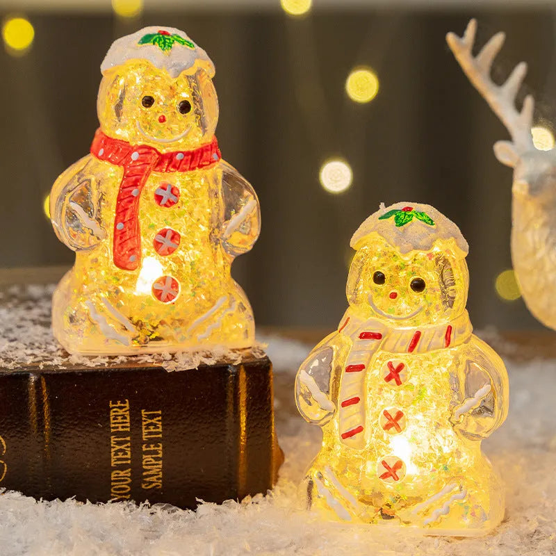Glowing LED gingerbread man snowman Christmas ornament with a red scarf on a festive tree.