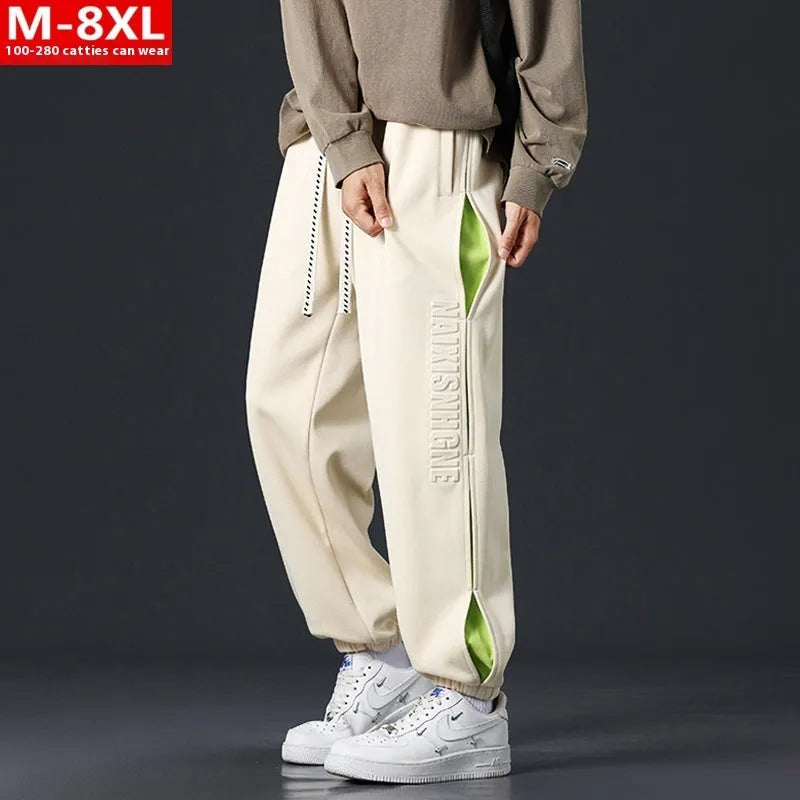 Men's loose-fit cotton trousers with printed stitching detail and ankle banding in grey green colour