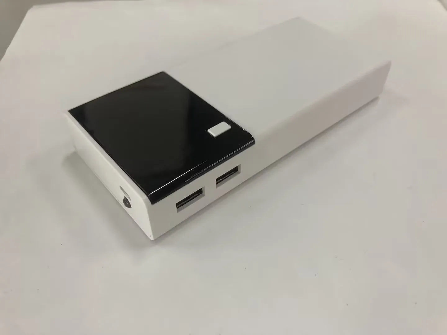 Black 20000mAh power bank showing compact 135x60x20mm dimensions with included charging cable