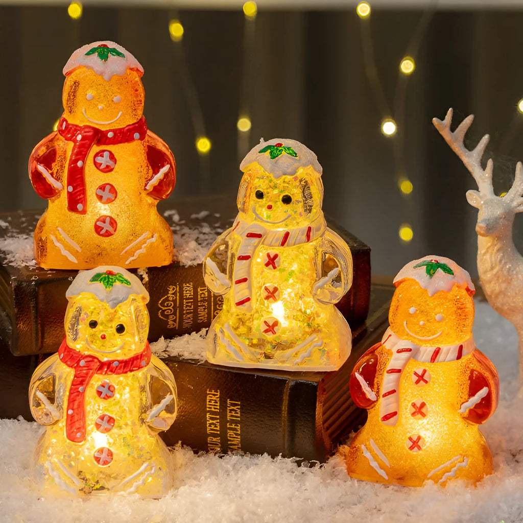 Glowing LED gingerbread man snowman Christmas ornament with a red scarf on a festive tree.