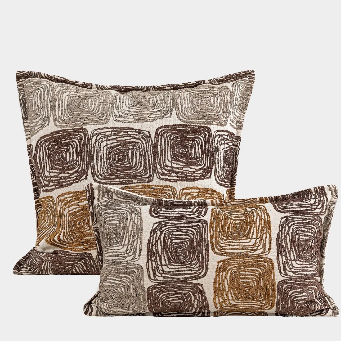 Cream and coffee-coloured abstract coil pattern on a square decorative pillow cover.