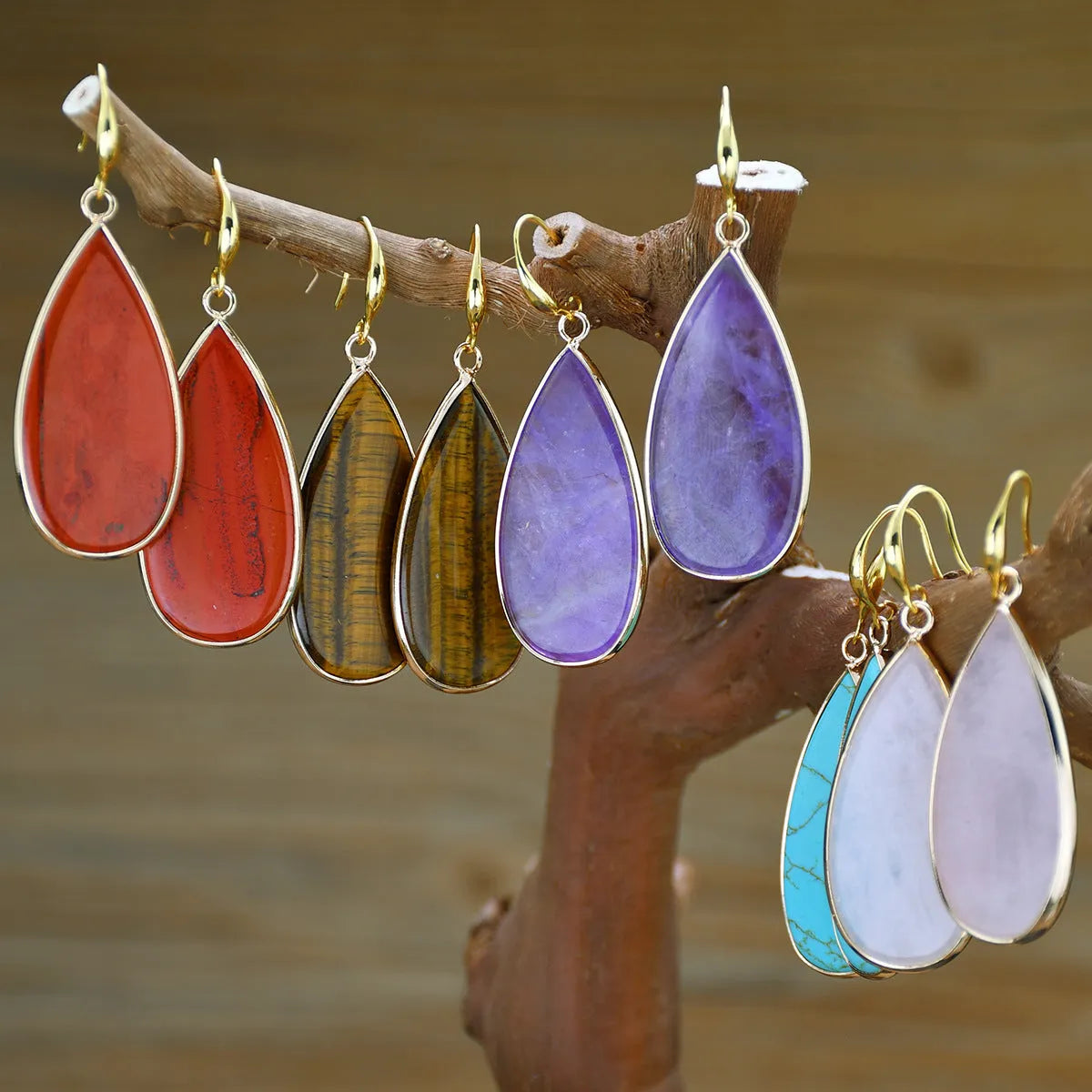 Vintage long water drop earrings in natural stone with textured surface and retro style