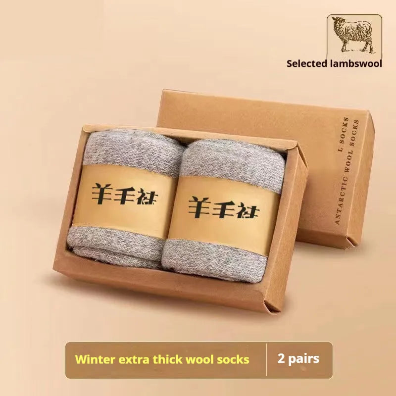 Pair of thick wool winter socks with a merino midsole in a neutral colour on a presentation box.