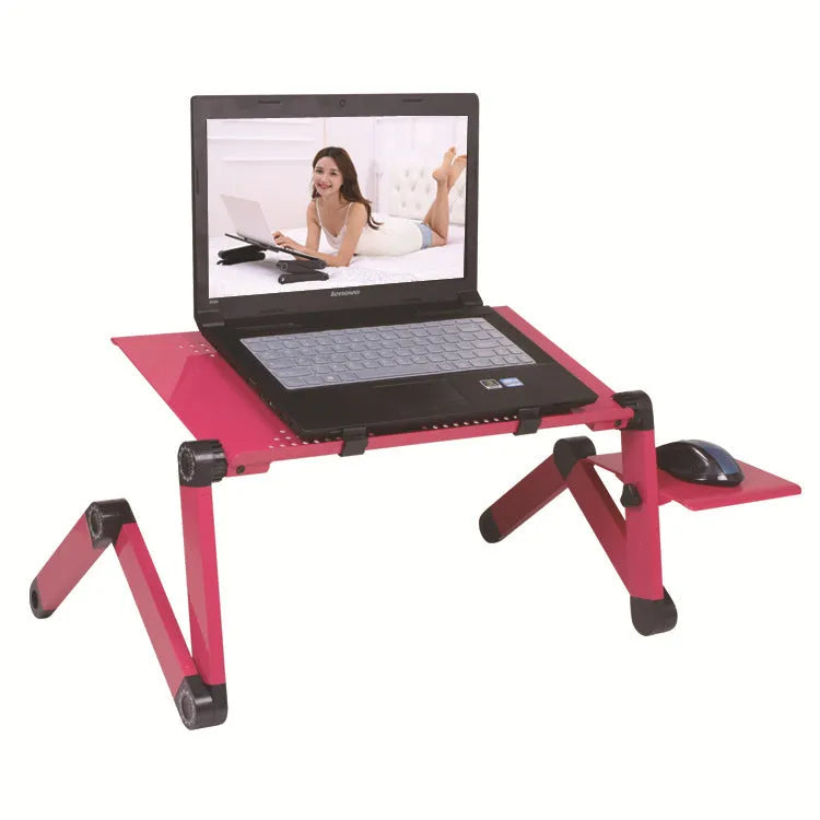 Black folding metal computer desk with laptop and cooling fan, extended on a sofa
