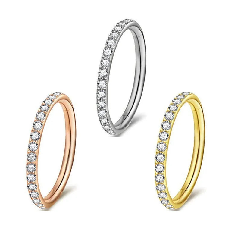 A round, seamless nose ring made of stainless steel, shown in various electroplated colour finishes including gold, rose gold, and black.