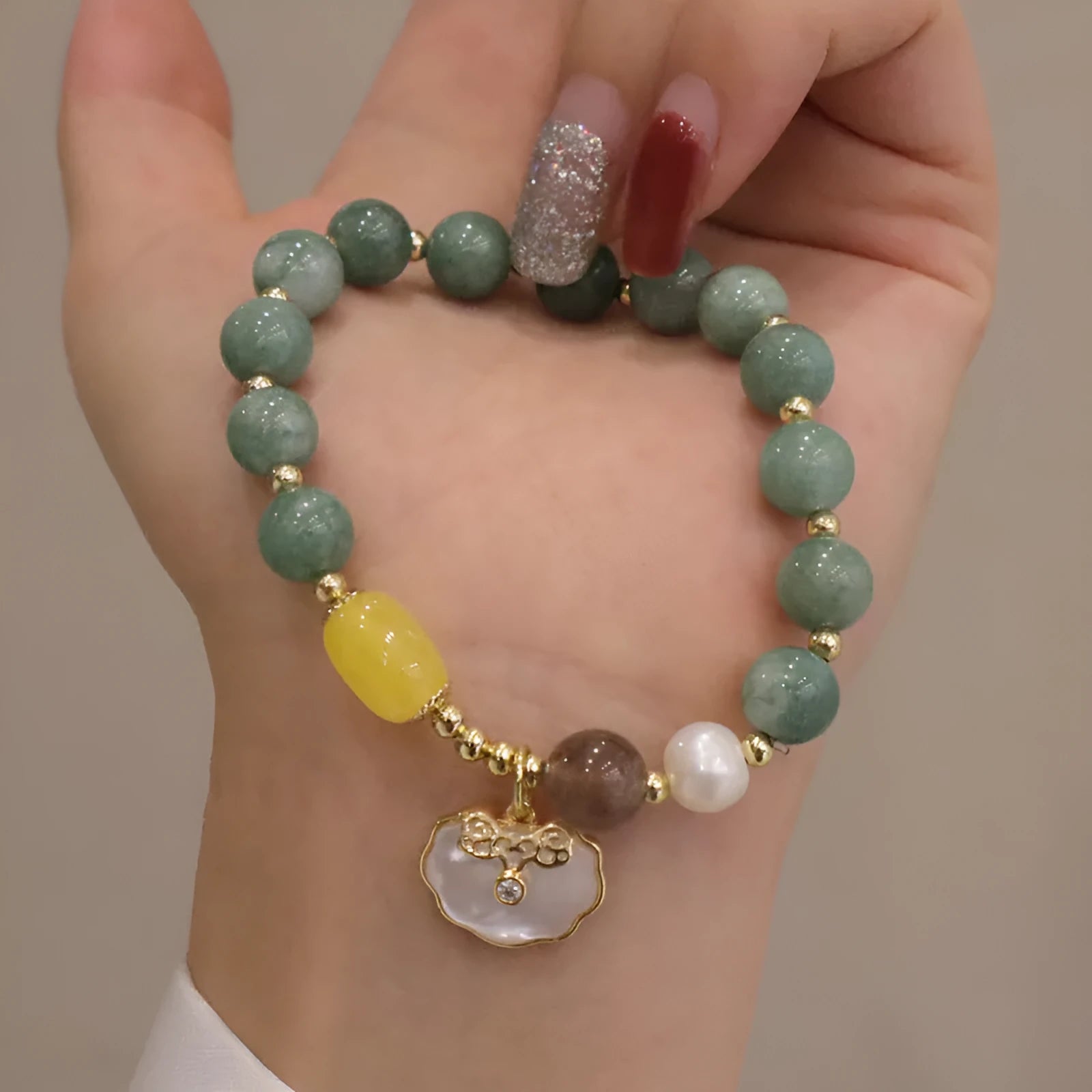 Natural green jade shell bracelet on display showing shell-shaped stone pieces in pictured colour