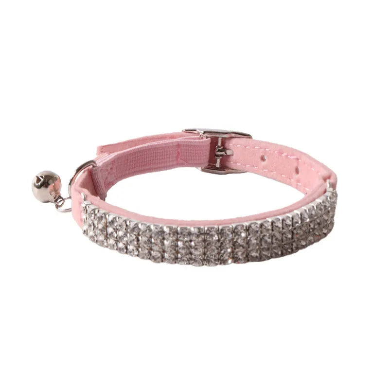Pink cat collar with elastic buckle and D-ring, made from soft flocking fabric.