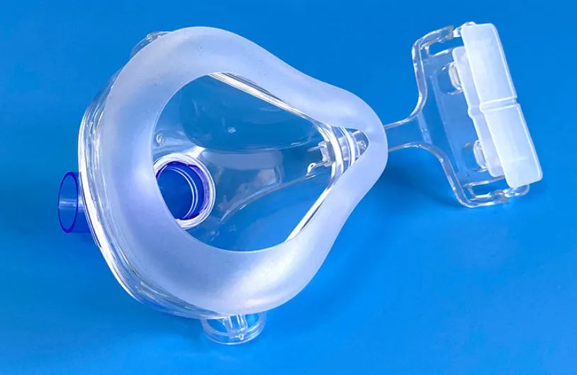 Transparent CPAP breathing mask with headband and dual elbow adapters for ventilator connection