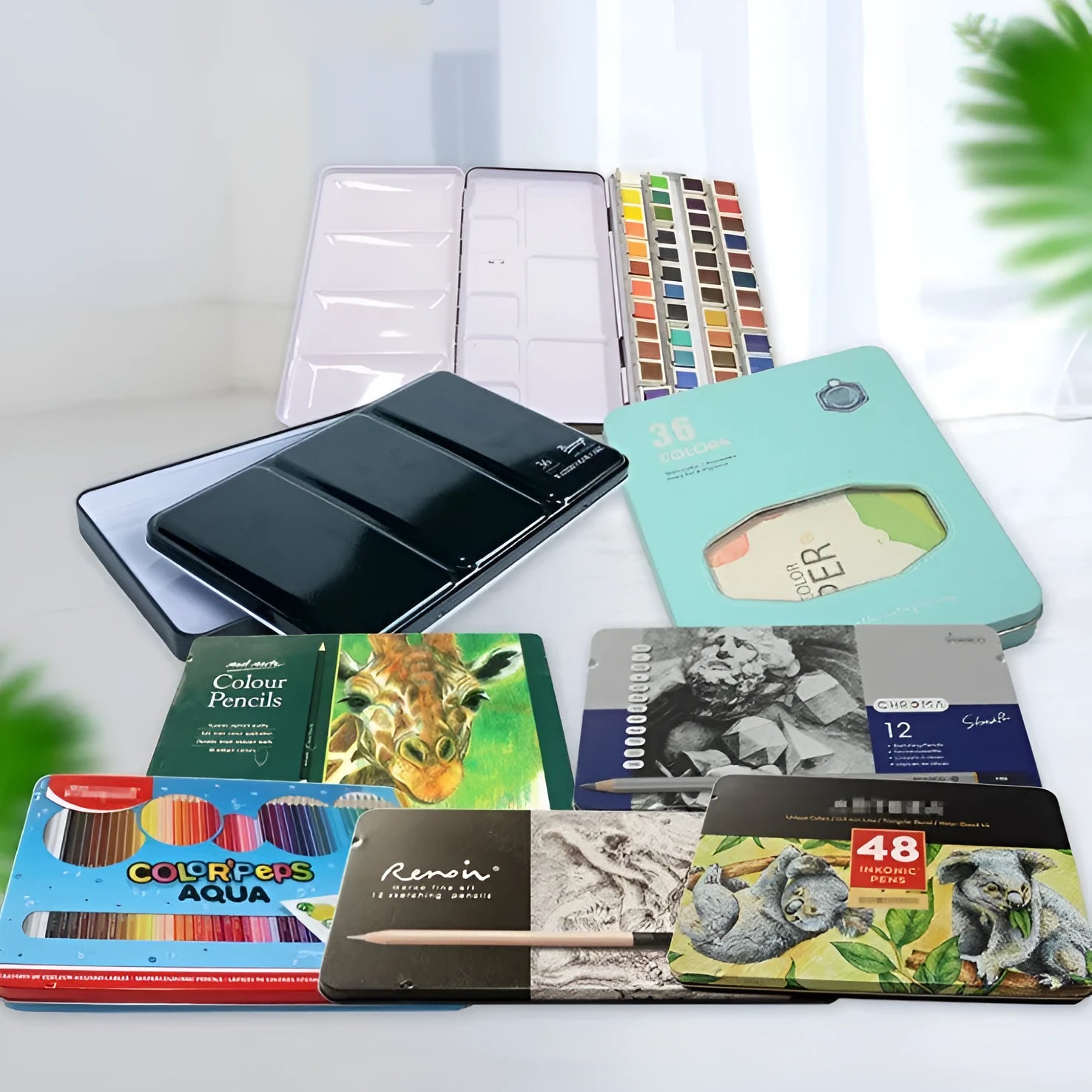 Solid tinplate paint box for watercolour pigments in a three-fold square design.