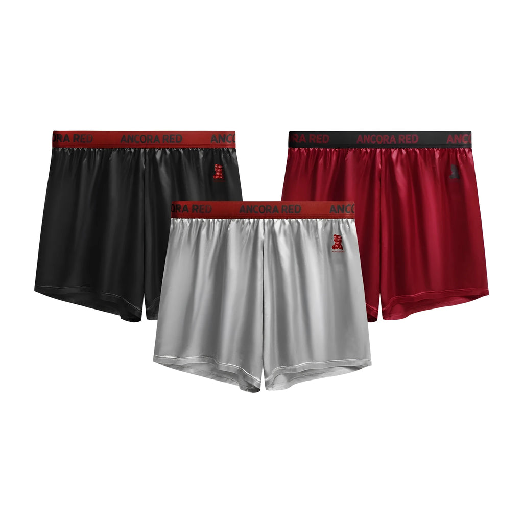 Solid colour men's boxer briefs on a mid waist, available in black, blue, red, silver, purple, and brown.