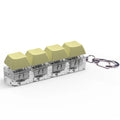 4-key mechanical shaft tester decompression toy with transparent bottom shell and coloured key caps.