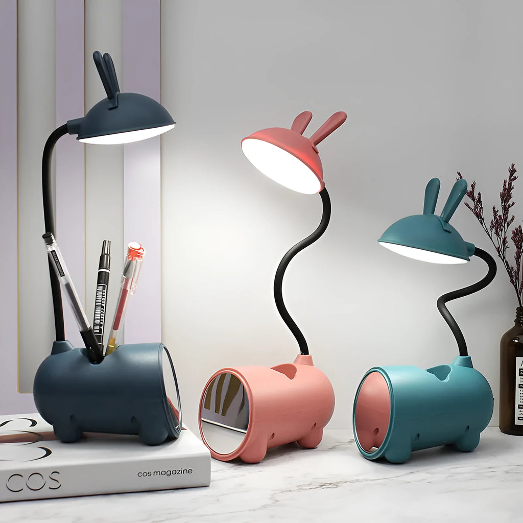 Cartoon-themed USB table lamp with pen container in green colour on desk