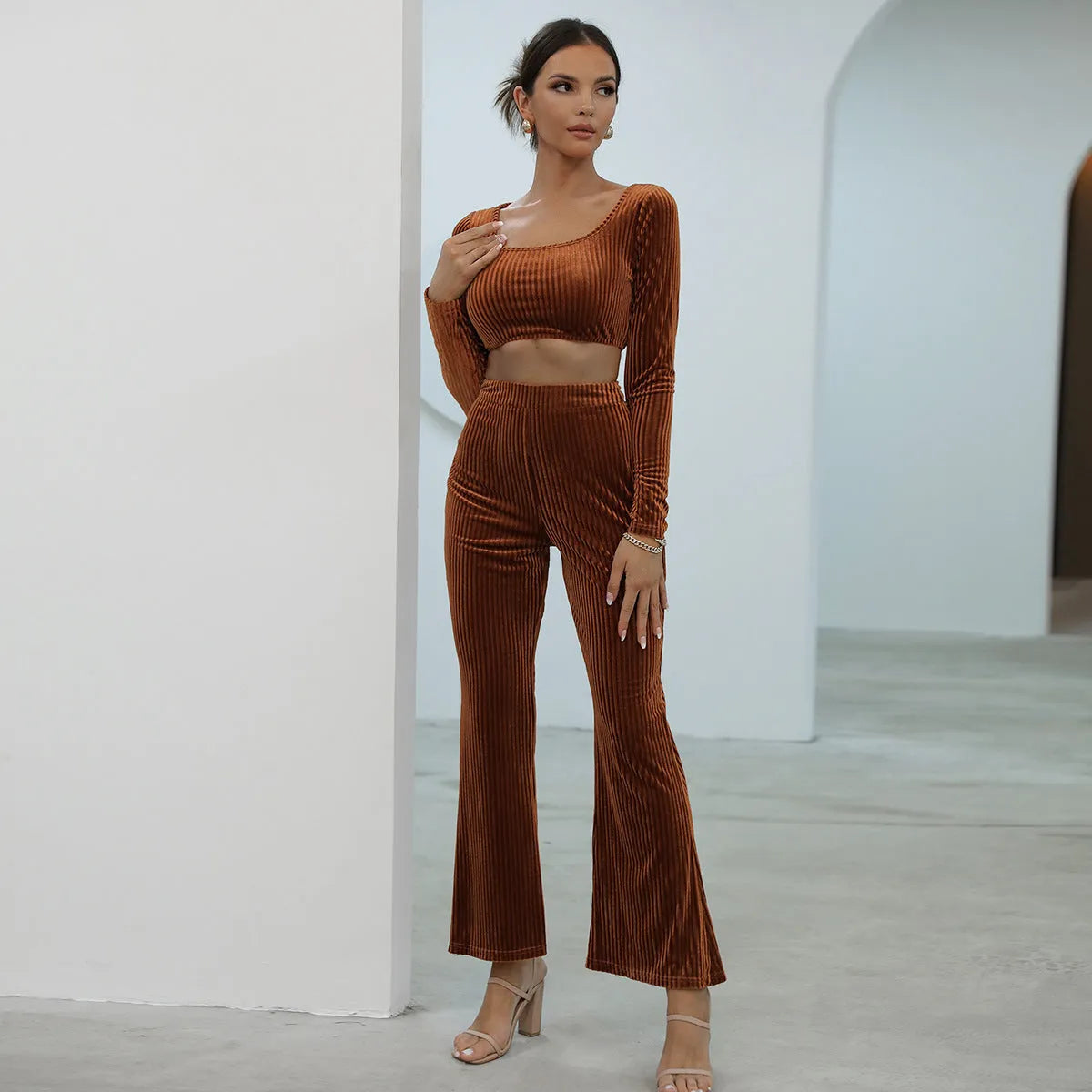 Caramel coloured long sleeve sweater and matching trousers loungewear set on a hanger