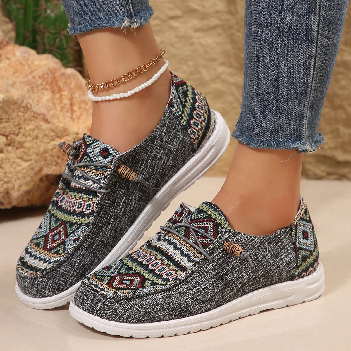 Women's black flat shoes with round toe and slip-on design on neutral background