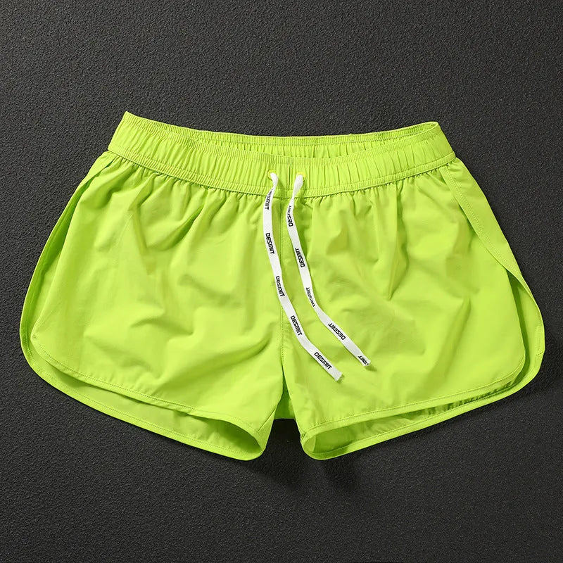 Men's loose fit elastic beach surfing shorts in orange, green, or black colours