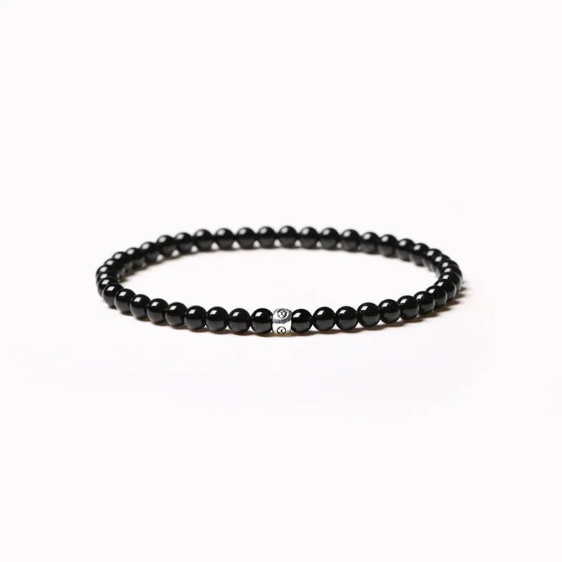 Geometric unisex bracelet with black obsidian, blue san, and cut black agate 4mm beads.