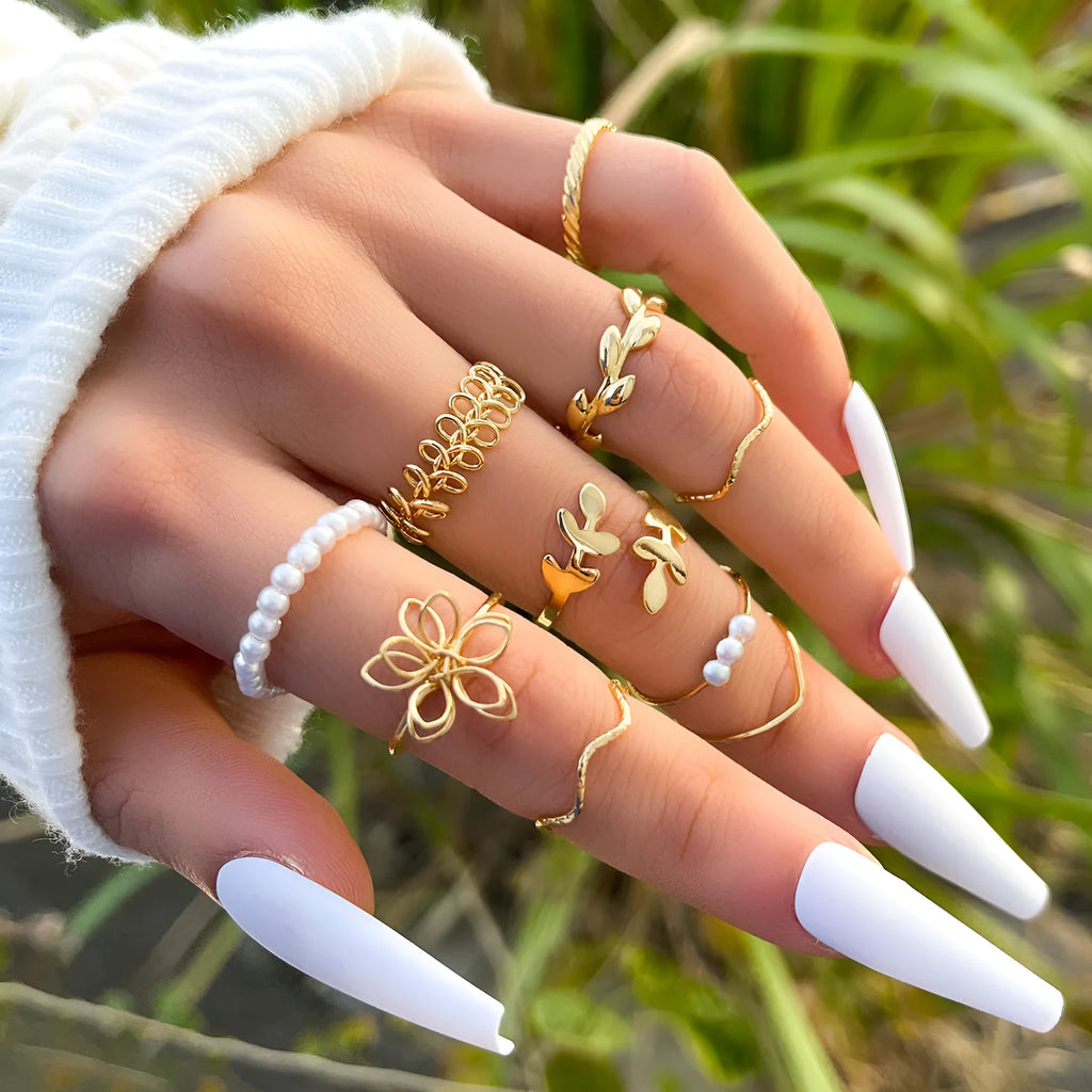 Gold-tone openwork floral ring with a glossy electroplated finish on an alloy band.