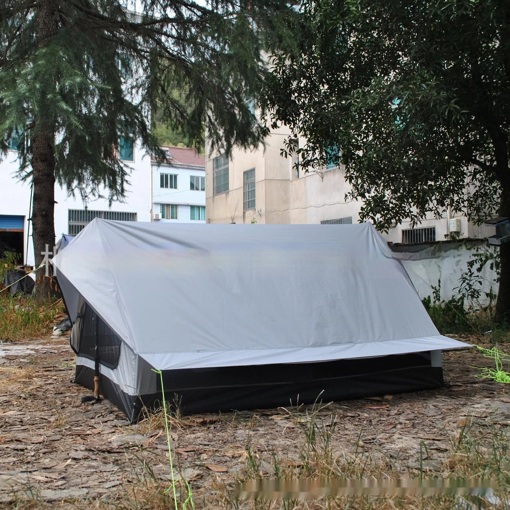Brown A-frame hiking tent supported by hiking poles showing spacious interior for 2-3 campers