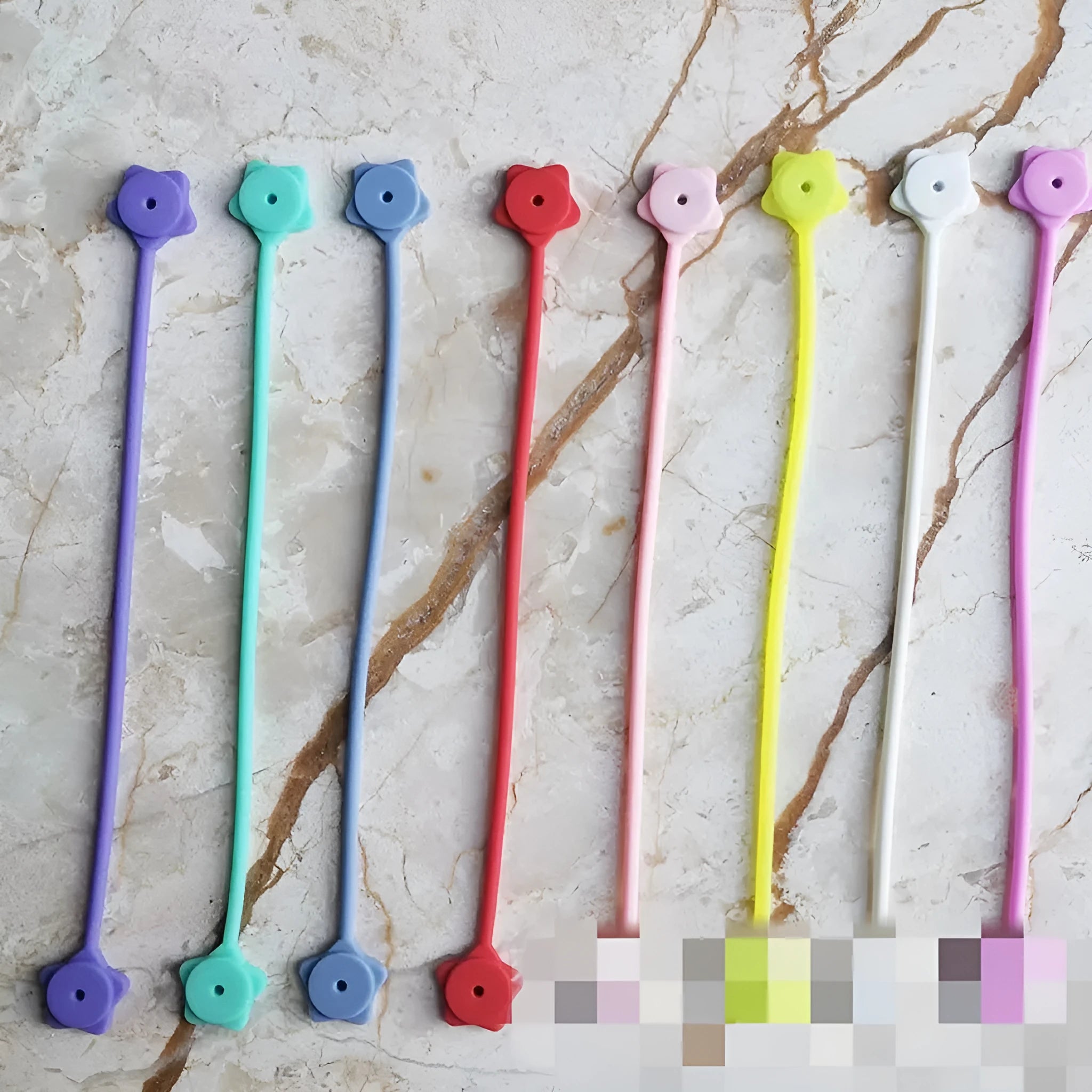 Silicone wire winder with magnet in lavender colour for organising headphone and mobile phone cables.